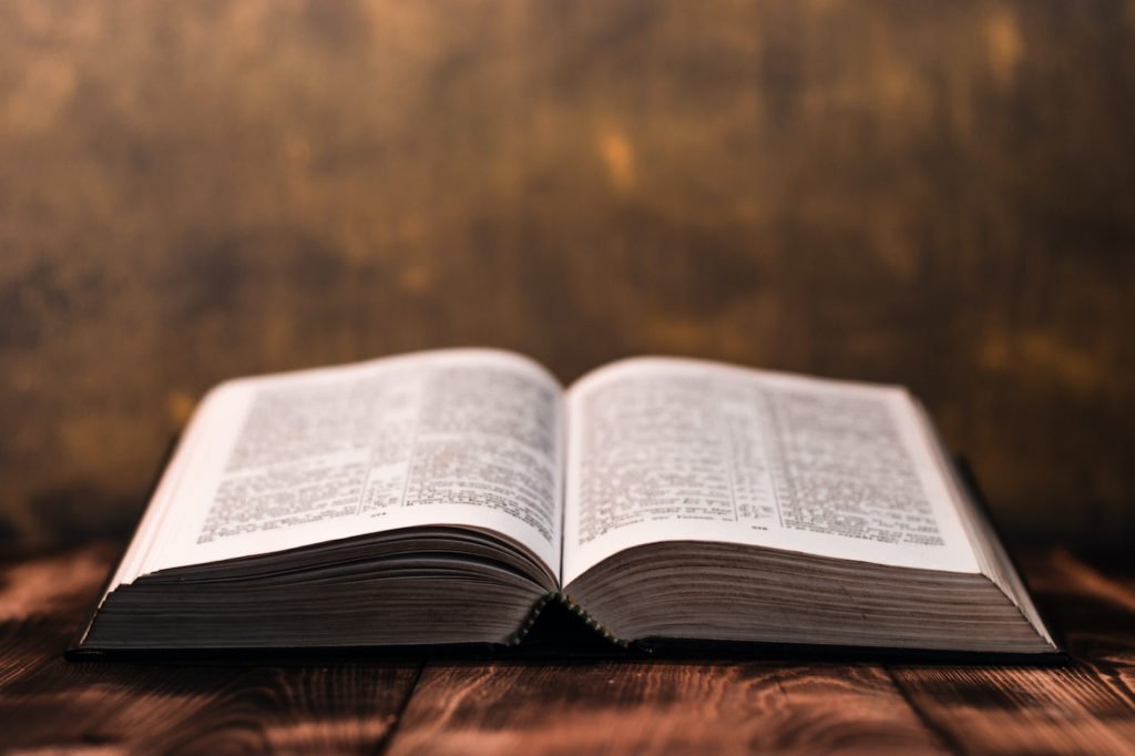 An open Bible on a wooden table
